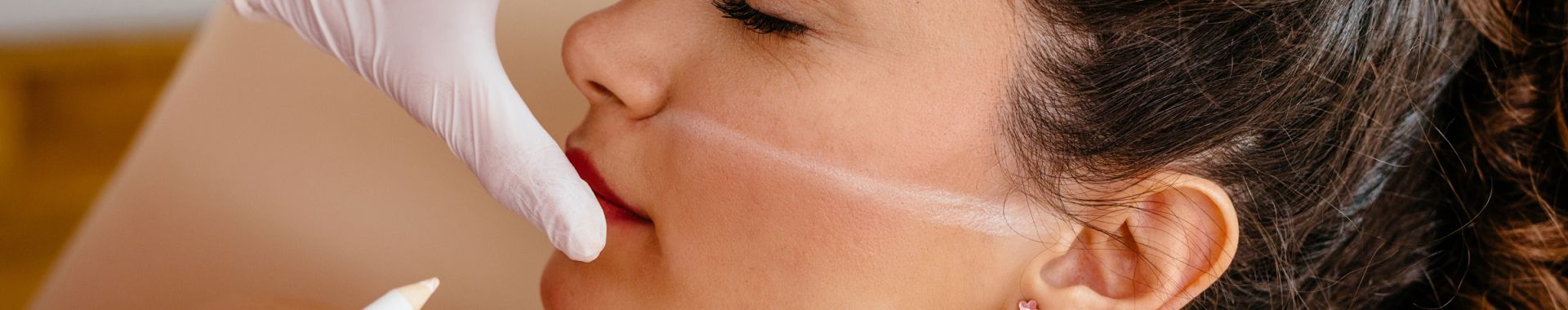 physician marking woman's face