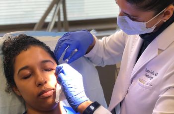 dr. pooja sodha performing procedure on patient